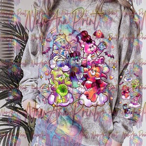 May include: A gray sweatshirt with a colorful print of Care Bears dressed in Halloween costumes. The print features a Care Bear dressed as a vampire, a Care Bear dressed as a mummy, and a Care Bear dressed as a witch. The print is surrounded by stars and clouds.