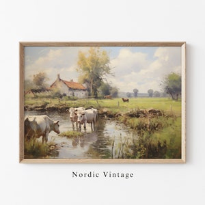 May include: A painting of a rural landscape with a white farmhouse, a stream, and cows grazing in a field. The sky is blue with white clouds. The painting is framed in a light wood frame.