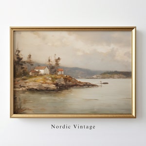May include: A framed painting of a landscape with a small white house on a rocky shore. The sky is cloudy and the water is calm. The painting is in a gold frame.