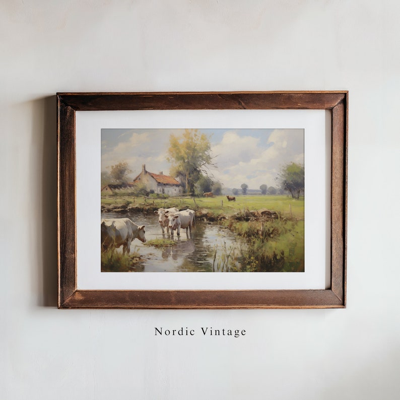 May include: A framed painting of a rural landscape with a white farmhouse, a stream, and white cows grazing in a field. The painting has a rustic, vintage feel.