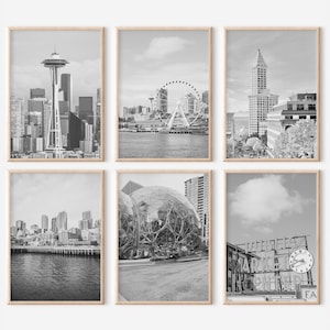 May include: A set of six black and white photographs of Seattle landmarks, including the Space Needle, the Ferris wheel, the Pike Place Market sign, and the city skyline.