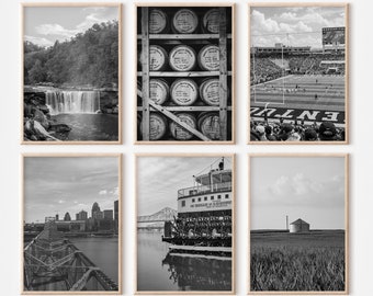 May include: A set of six black and white photographs in wooden frames. The photos depict various scenes, including a waterfall, a stadium, a riverboat, a city skyline, a field of grass, and a stack of barrels.