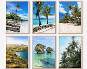 May include: Six framed art prints featuring tropical beach scenes. The images showcase palm trees, white sand beaches, and clear blue water under sunny skies. The prints are displayed in light-colored wooden frames.