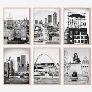 May include: Six framed monochrome photographs of cityscapes. The images depict buildings, bridges, and monuments. The photographs are arranged in a grid, displaying diverse urban scenes.