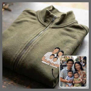 May include: An olive green zip-up sweatshirt featuring a custom embroidered graphic of a family portrait. The design depicts two adults and two children in white shirts, based on the included reference photograph of a family of four.