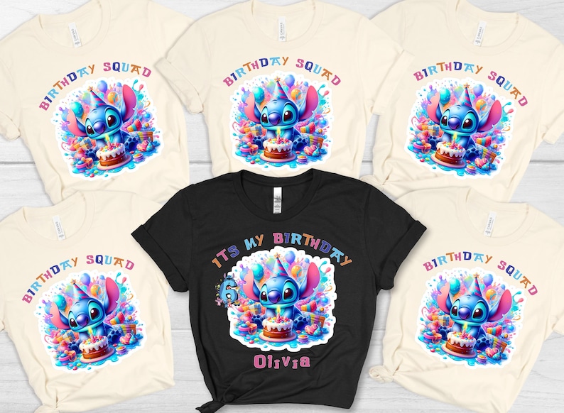 May include: Several t-shirts with a vibrant design of a blue alien holding a birthday cake. The shirts are in black and cream, with the words "Birthday Squad" and "It's My Birthday" printed on them. A fun, colourful design.