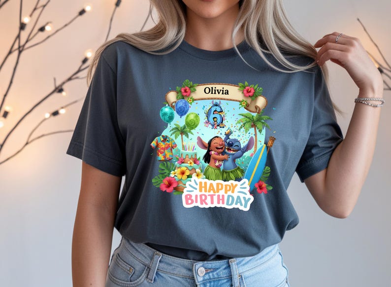May include: A dark gray t-shirt featuring a colorful graphic of Lilo and Stitch celebrating a birthday. The design includes the name "Olivia", the number 6, tropical flowers, and the words "Happy Birthday".