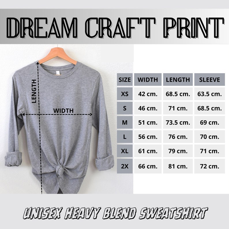 May include: A light gray unisex heavy blend sweatshirt displayed on a wooden hanger. The image includes a size chart with measurements in centimeters for width, length, and sleeve length. The text "DREAM CRAFT PRINT" and "UNISEX HEAVY BLEND SWEATSHIRT" are visible.