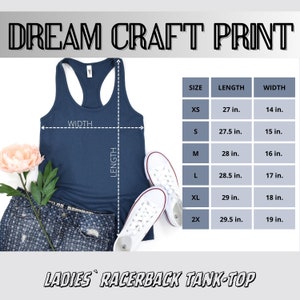May include: Navy blue racerback tank top with size chart. The tank top is displayed with a pair of white sneakers, denim shorts, and a pink flower. The text "DREAM CRAFT PRINT" and "LADIES RACERBACK TANK-TOP" are visible.