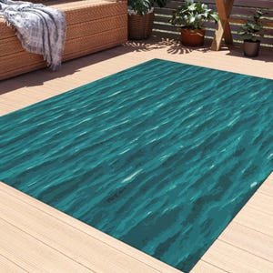 Shimmering Turquoise Water Outdoor Rug. Featuring dynamic horizontal strokes in layered shades of teal, turquoise, and seafoam. 4 sizes.