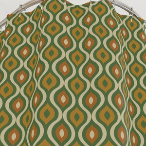 May include: A green, orange, and cream shower curtain with a repeating pattern of abstract shapes.