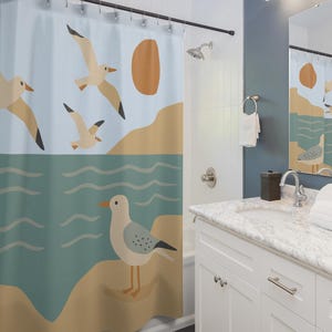 May include: A shower curtain with a coastal design featuring seagulls, a sun, and ocean waves. The top half is a light blue sky with flying seagulls and a brown sun. The bottom half is a teal ocean with a seagull standing on a sandy beach.