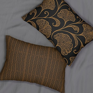 Ginkgo Leaves Lumbar Pillow. On one side are graceful copper and brown ginkgo leaves on black; on the other is a fun brown pattern on black.