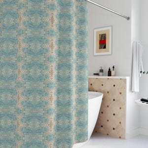 May include: A teal and beige mosaic patterned shower curtain hangs from a curved, silver-colored rod. The curtain's design features a repeating pattern of small, circular shapes in shades of teal, beige, and white. The bathroom has white walls and a white bathtub.
