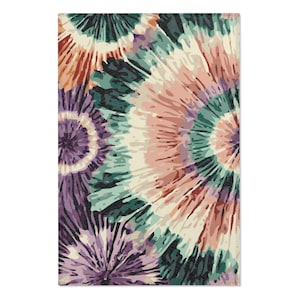 May include: A colorful tie-dye pattern rug with shades of purple, green, and pink. The rug has a circular design with a white background.