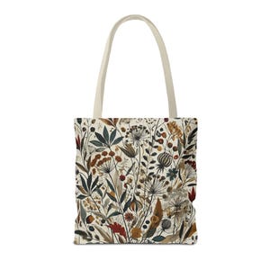 Whimsical Botanical Tote Bag. Featuring an intricate, unique and artistic design of various flowers, leaves, and branches in earthy tones.