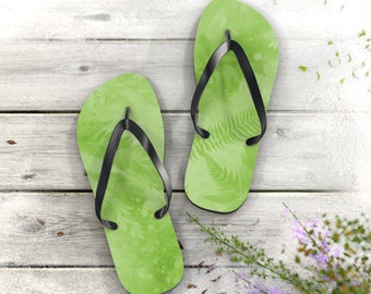 Walk the Earth Flip Flops. Unisex. Embrace your love for the planet with these flip-flops. Designed with a lush green foliage print.