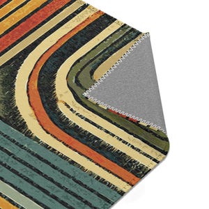 Worn Look Retro Area Rug. Featuring circles and stripes in an earthy color palette of deep orange, mustard yellow, olive green, and teal.