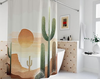 Cactus Sunset Cloth Shower Curtain. Featuring tall, elegant green cacti against brown and orange desert cliffs and a glowing sunset at dusk.