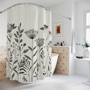 May include: A white shower curtain with a black and brown floral pattern. The curtain features stylized drawings of various plants and flowers.