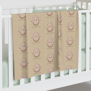 Potato Baby Swaddle Blanket. Adorned with charming smiling potatoes accompanied by the phrase &quot;our little potato.&quot; Matching swaddle in shop.