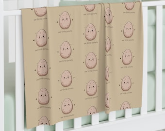 Potato Baby Swaddle Blanket. Adorned with charming smiling potatoes accompanied by the phrase &quot;our little potato.&quot; Matching swaddle in shop.
