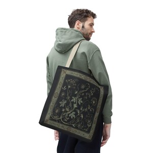 Vintage Inspired Botanical Tote Bag. A tapestry-inspired border frames olive green wildflowers and vines on black. 3 sizes, 2 strap colors.