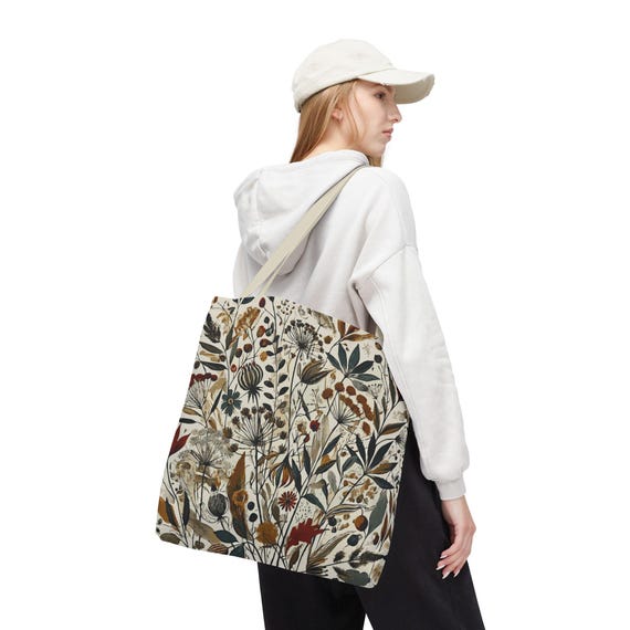 Whimsical Botanical Tote Bag. Featuring an intricate, unique and artistic design of various flowers, leaves, and branches in earthy tones.