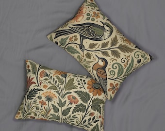 Vintage-Inspired Botanical and Bird Lumbar Pillow. Featuring 2 birds perched in foliage on 1 side, and flowers and leaves on the other.