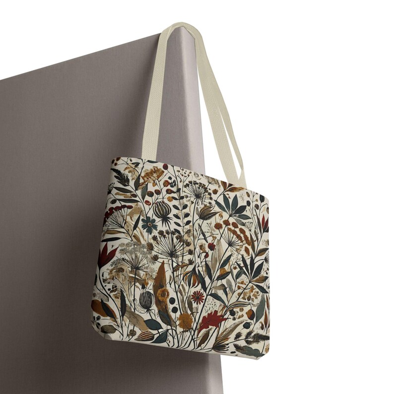 Whimsical Botanical Tote Bag. Featuring an intricate, unique and artistic design of various flowers, leaves, and branches in earthy tones.