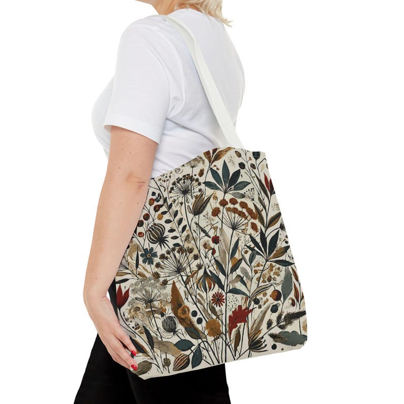 Whimsical Botanical Tote Bag. Featuring an intricate, unique and artistic design of various flowers, leaves, and branches in earthy tones.