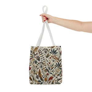 Whimsical Botanical Tote Bag. Featuring an intricate, unique and artistic design of various flowers, leaves, and branches in earthy tones.