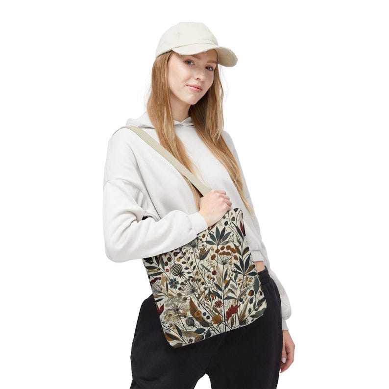 Whimsical Botanical Tote Bag. Featuring an intricate, unique and artistic design of various flowers, leaves, and branches in earthy tones.