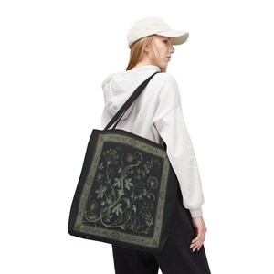 Vintage Inspired Botanical Tote Bag. A tapestry-inspired border frames olive green wildflowers and vines on black. 3 sizes, 2 strap colors.