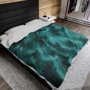 May include: A teal and black abstract patterned duvet cover with a white underside. The duvet cover is on a bed with a black headboard.