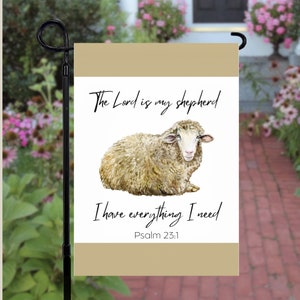 May include: A beige garden flag with a white sheep illustration and the text "The Lord is my shepherd I have everything I need Psalm 23:1"