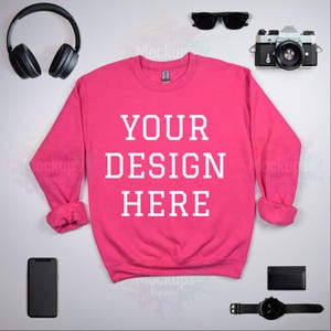 Gildan 18000 Heliconia sweatshirt mockup front flat lay showcasing stylish accessories. Perfect for presenting your design ideas!