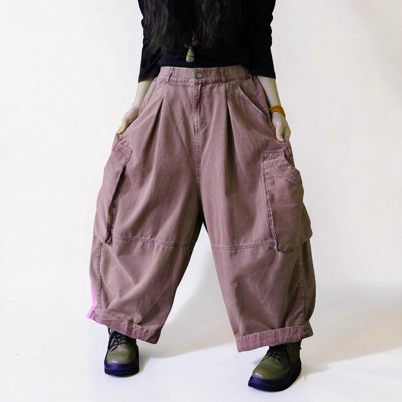 Vintage washed dusty pink balloon workwear pants with a high waist and oversized cargo pockets.