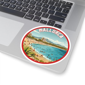 May include: A red and white circular sticker with the word "MALLORCA" in red letters. The sticker features a beach scene with people swimming and sunbathing.