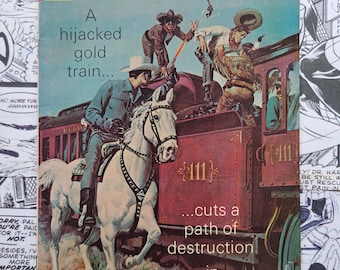 May include: Vintage "The Lone Ranger" comic book cover. The cover features a cowboy on a white horse, a train, and cowboys fighting. Text includes "A hijacked gold train... cuts a path of destruction in DETOUR!" and the Whitman logo.