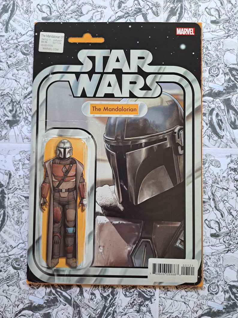 May include: A Star Wars action figure of The Mandalorian in a retro-style package. The packaging features the Star Wars logo, the Marvel logo, and an illustration of the character. The figure is in a clear plastic bubble.