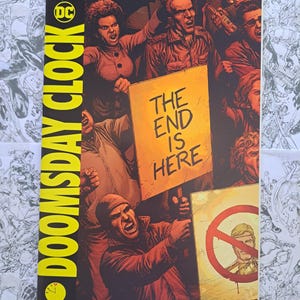 May include: Comic book cover for "Doomsday Clock" No. 1 of 12, featuring a crowd of people with angry expressions. A sign reads "THE END IS HERE." The DC Comics logo is visible, along with the date January 2018.
