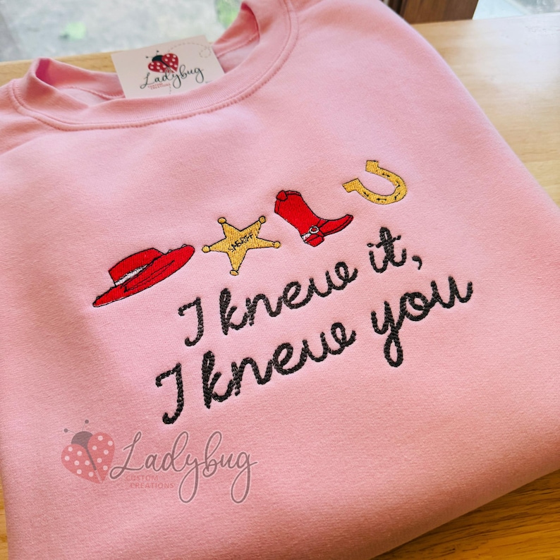 Embroidered "I Knew It I Knew You" sweatshirt featuring western rope lettering and a cowboy hat design on a cozy crewneck sweatshirt.