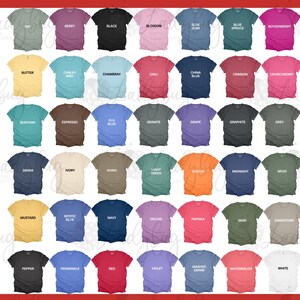 May include: A color chart displaying forty-two short-sleeve t-shirts arranged in a grid. Each shirt features a unique color name printed in black text across the chest, including shades like black, white, red, blue, green, yellow, and various neutrals.