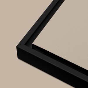 May include: A black framed canvas print with a beige background. The frame is thick and has a smooth finish.