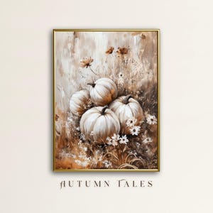 May include: A painting depicting white pumpkins nestled amongst brown and white flowers in a field. The pumpkins are arranged in a cluster, with the largest pumpkin at the centre. The background is a soft brown colour, with hints of white and green. The painting is framed in a gold frame.