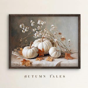 May include: A framed still life painting featuring white pumpkins, dried leaves, and delicate white flowers. The pumpkins vary in size and are arranged on a draped surface. The artwork has a muted color palette with the text "AUTUMN TALES" at the bottom.