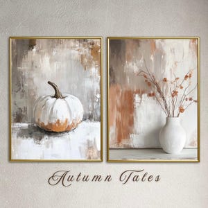 May include: Two framed abstract paintings with a white pumpkin on the left and a white vase with dried branches on the right. The paintings have a neutral color palette of white, brown, and beige. The text "Autumn Tales" is written below the paintings.