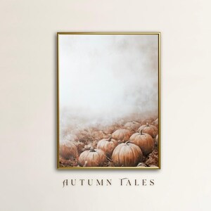 May include: A digital art print of a field of pumpkins in a foggy, autumnal setting. The pumpkins are various shades of orange and brown, and the background is a soft, hazy white.