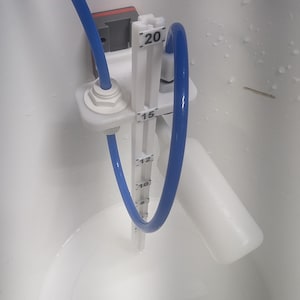 May include: A white bucket with a blue tube and a white measuring device. The device has markings for 10, 12, 15, and 20. A warning label in a brown circle reads "WARNING 3D PRINTED PARTS ONLY!"